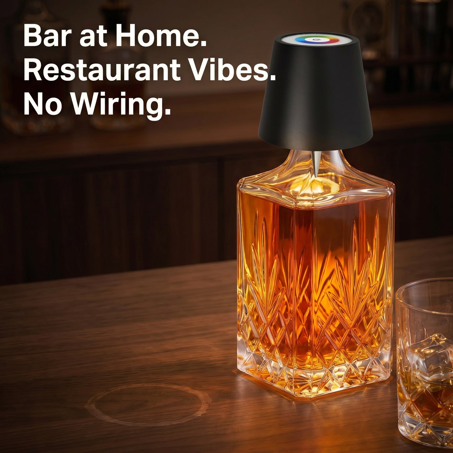 Wireless bottle lamp glowing warm amber in whiskey bottle on dark wood home bar, no wiring