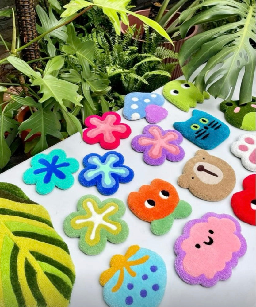 Colourful flower-shaped objects on a green background